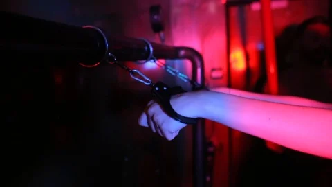 Close-up of a girl's hands handcuffed to a pipe Stock Footage 117770012