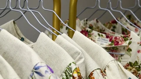 A close-up of a girl's hands looking through an assortment of clothes neatl.. 動画素材 339766445