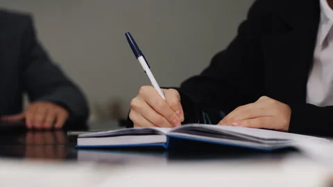 Close-up of a girl's hands taking notes in a notebook with a blue ballpoint pen. Stock Footage 287295454