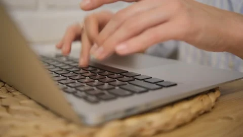 Close-up of the girl's hands typing text. Side view. Green laptop screen. Select Stock Footage 149610035