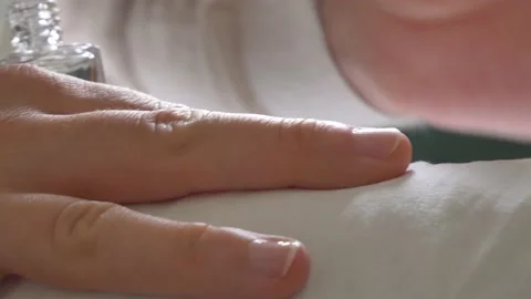 A close-up of a girl's hands while she is putting on her nail polish. Stock Footage 130906264