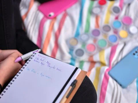 Close-up of a girl's notebook with notes on possible make-ups Stock Photos