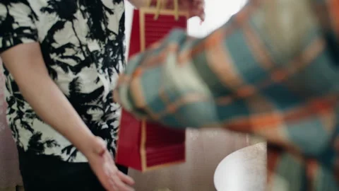 Close up of giving a gift and scene of celebration of family holiday Video stock 330498138