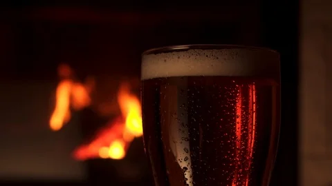 Close-up glass bocal of refreshment cooled beer with foam fireplace in Stock Footage 103549608