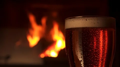 Close-up glass bocal of refreshment cooled beer with foam fireplace in 動画素材 103549781