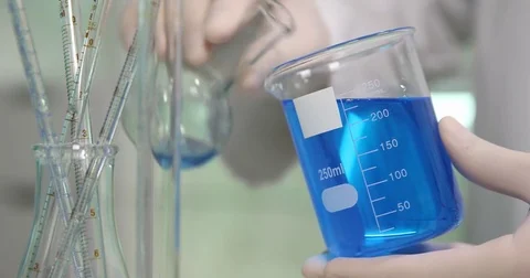 Close Up of Glass Bottle with Experimental Solution Liquid Mixing in Laboratory Stock Footage