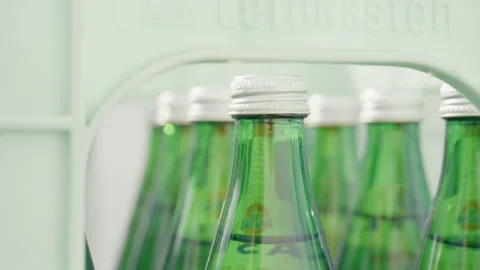 Close Up of Glass Bottles and Bottle Caps in Beverage Crate Stock Footage 345895216