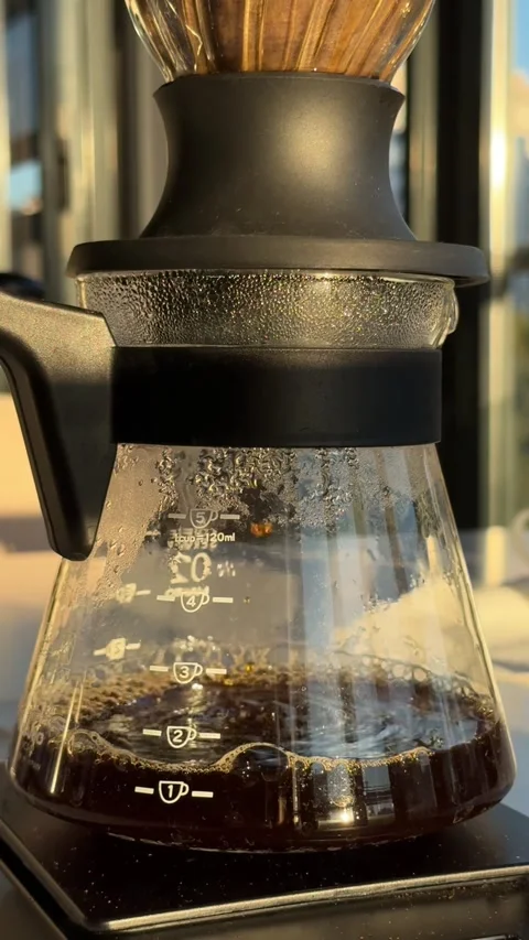Close-up of a glass coffee server with freshly brewed coffee dripping Stock Footage 297373533