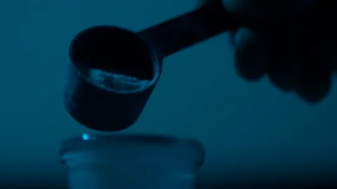 Close-up - a glass container, into which powder is poured from a measuring ladle Stock Footage 143629760