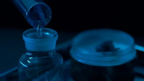 Close-up is a glass container into which water is poured from another container. Stock Footage 143629256