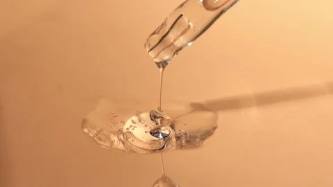 Close-up of a glass dropper with a clear liquid serum, hyaluronic acid. Stock Footage 218314067