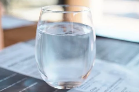 Close-up of a glass filled with clean still water on a table Stock Photos