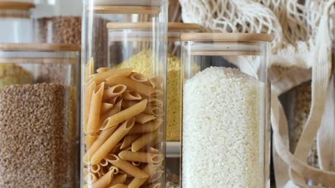 Close-up of glass jars with rice and pasta. Stock Footage 280141402