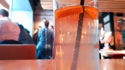 Close up of the glass with lemonade, blurred background with people Stock Footage 103836144