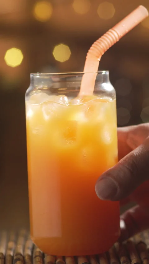 Close-up. Glass with refreshing summer orange cocktail made with citrus jui.. Stock Footage 340068214