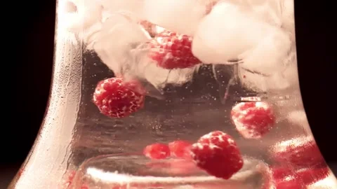 Close up of glass transparent flask of hookah with ice and raspberry Stock Footage 149898474