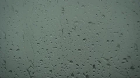 Close up of a glass with water drops while outside is raining. Drops of rain Video stock 138025576