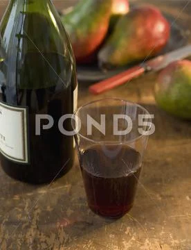 Close up of glass of wine and wine bottle Stock Photos