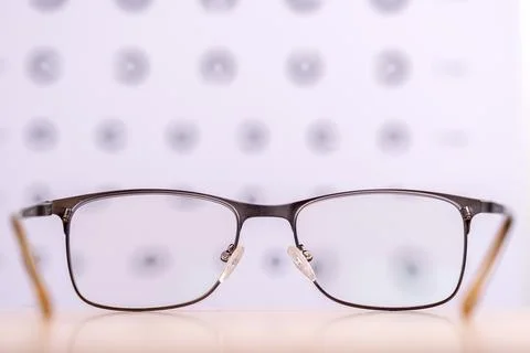 Close -up glasses against background of table for checking vision, concept .. Stock Photos