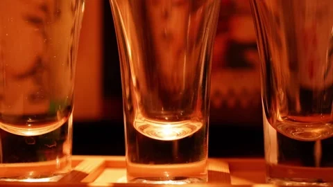 Close-Up of Glasses with Amber Liquid Vídeo Stock 309365620
