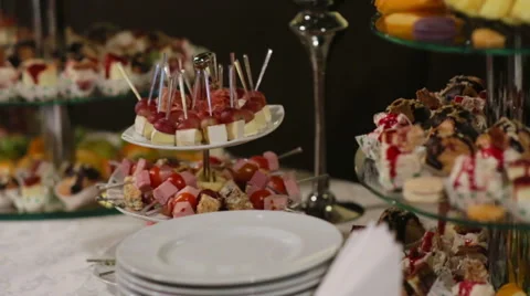 Close up of glasses and guests taking food from a table Stock Footage 61373662