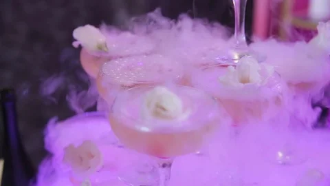 Close-up glasses in form of pyramid and they flowed champagne Stock Footage 100686517