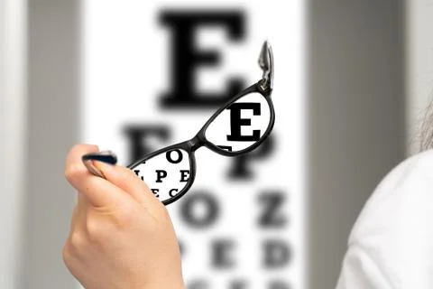 Close up of glasses in front of eye chart Fotos de archivo