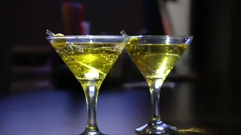 Close-up. glasses with martini or gin on the bar. Martini with olive. Stock Footage 126812025