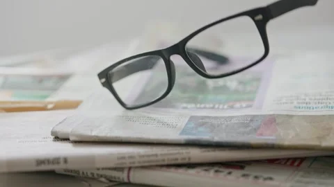 A close up of the glasses on the newspaper. Stock Footage 296549114