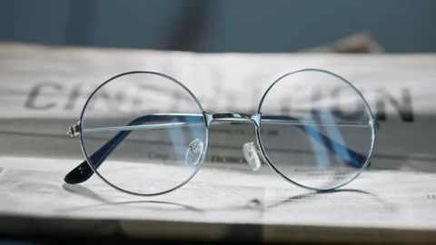 A close up of the glasses on the newspaper. Vídeo Stock 296549182