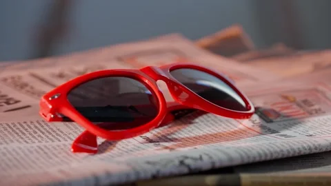 A close up of the glasses on the newspaper. Vídeo Stock 296549406