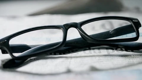 A close up of the glasses on the newspaper. Stock Footage 296549587
