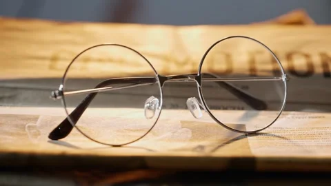 A close up of the glasses on the newspaper. Stock Footage 296549714