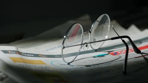 A close up of the glasses on the newspaper. Stock Footage 296549967