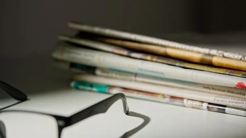 A close up of the glasses on the newspaper. Stock Footage 296550049