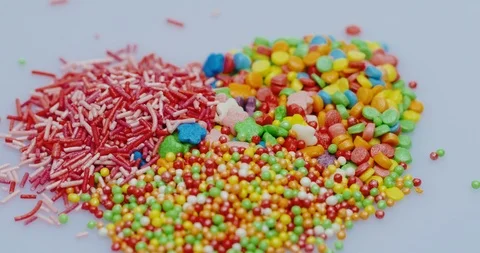 Close up of the glazed small colourful candies of different kinds lying on the Stock Footage 86538197