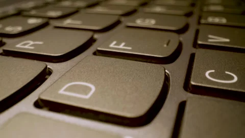 Close up gliding shot of modern laptop keyboard keys Stock Footage 340902447