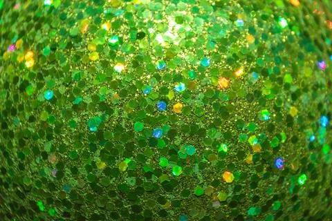 A close-up of a glittering green surface, featuring hexagonal reflective part Stock Photos