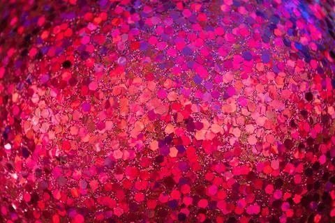 A close-up of a glittering pink surface, featuring hexagonal reflective par.. Stock Photos