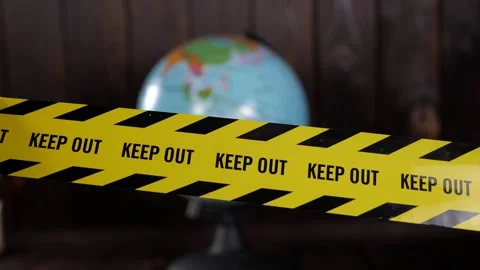 A close-up of the globe with a yellow warning tape reading KEEP OUT. Stock Footage 328024511