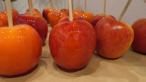 Close-up of Glossy Red Candy Apples on Wooden Sticks Stock Footage 345292550