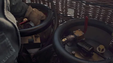 Close up of a gloved hand on the controls of a hot-air balloon Stock Footage 240921714