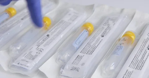 Close Up of Gloved Hand Counting COVID Swab Kits Stock Footage 129415594