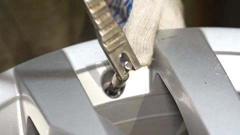 Close-up of gloved hand installing metallic part into silver machinery Stock Footage 347902371