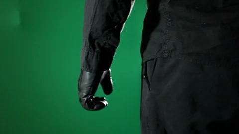Close-up of gloved hand making a fist in front of a green screen Video stock 97909486