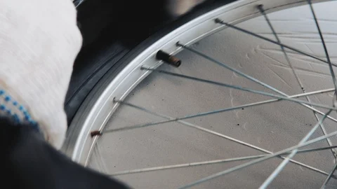 Close-up of a gloved hand mounts a new camera on a bicycle wheel tire. Stock Footage 115126324