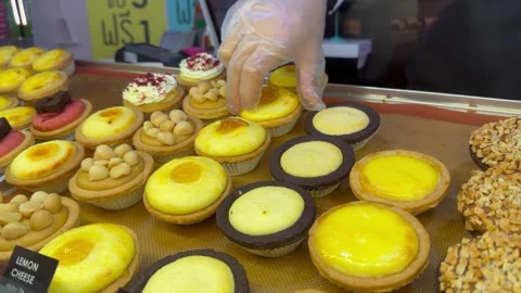 Close-Up of Gloved Hand Placing Cheese on Lemon Tart Stock Footage 279053778