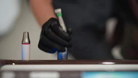 Close up of gloved hand reaching for dental instruments on countertop with soft Stock Footage 345072694