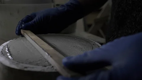 Close-up of gloved hands leveling fresh concrete with a special ruler.4k video Stock Footage 117048319