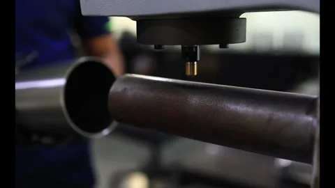 Close-up of gloved hands positioning a chrome-plated cylinder for hardness Stock Footage 337022879